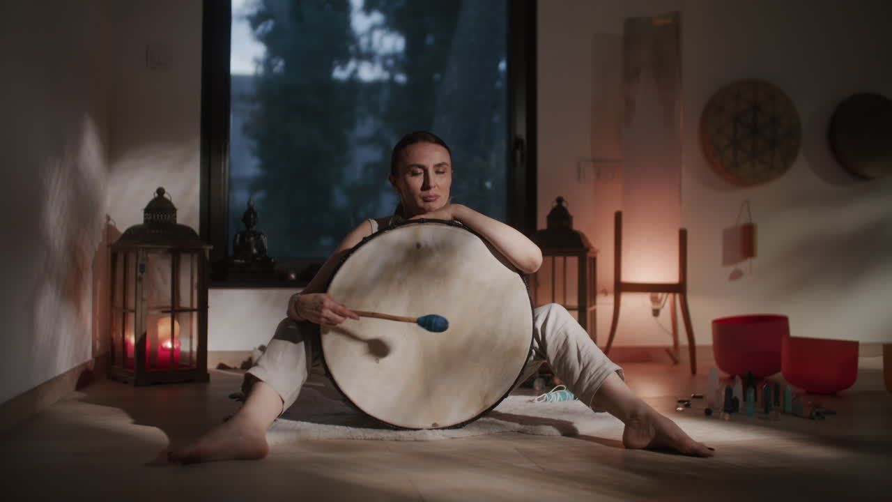 Woman Playing Drum in Meditation Space