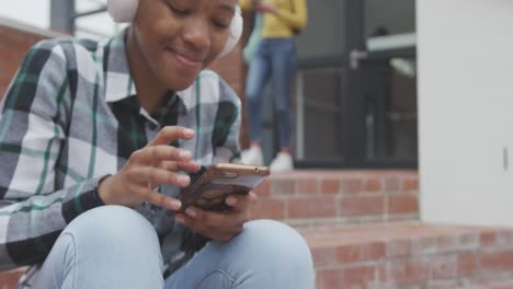 student listening to music outside high school