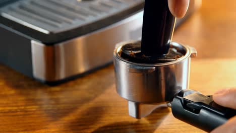 Tamping-coffee-in-a-portafilter-4k