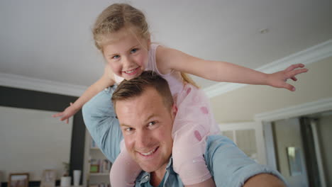 happy father carrying little girl on his shoulders dad holding his daughter enjoying playful game at home video chat concept 4k