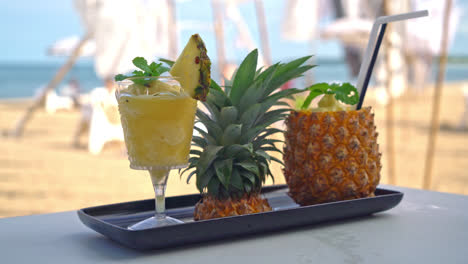 fresh pineapple smoothies with sea beach background