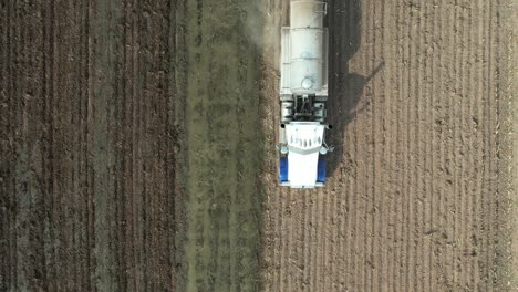 a tanker spreads liquid manure on a wisconsin farm field recently harvested of corn silage