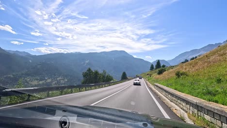 car driving through mountainous road in piedmont, italy