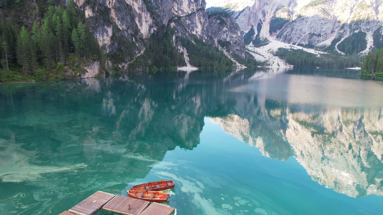 Incredible aerial view of turquoise lake water of Braies in Dolomiti, Italy