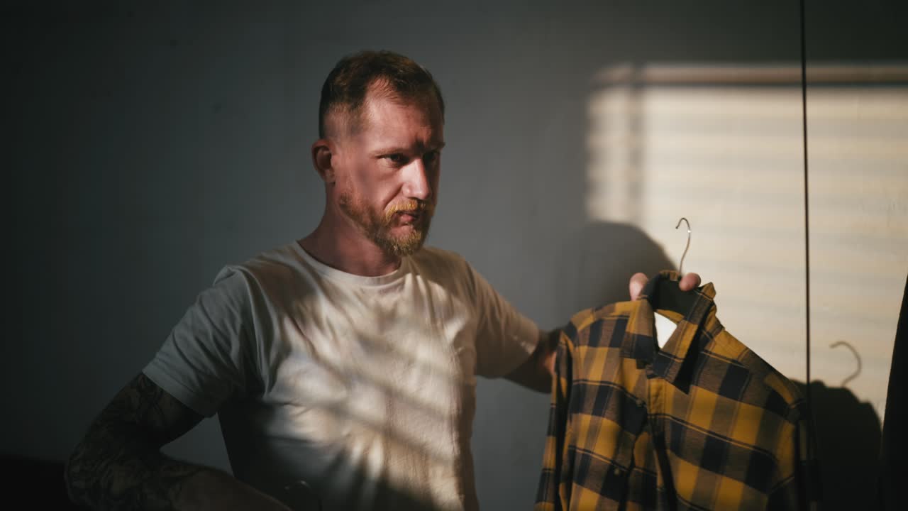 Man Choosing Clothes from Wardrobe