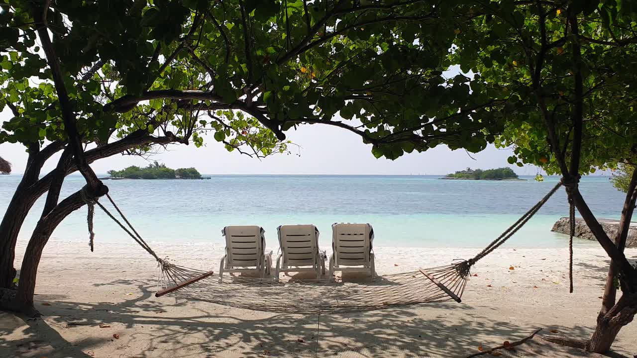 Beach chairs  and hammock on seashore in Maldives. Lockdown shot