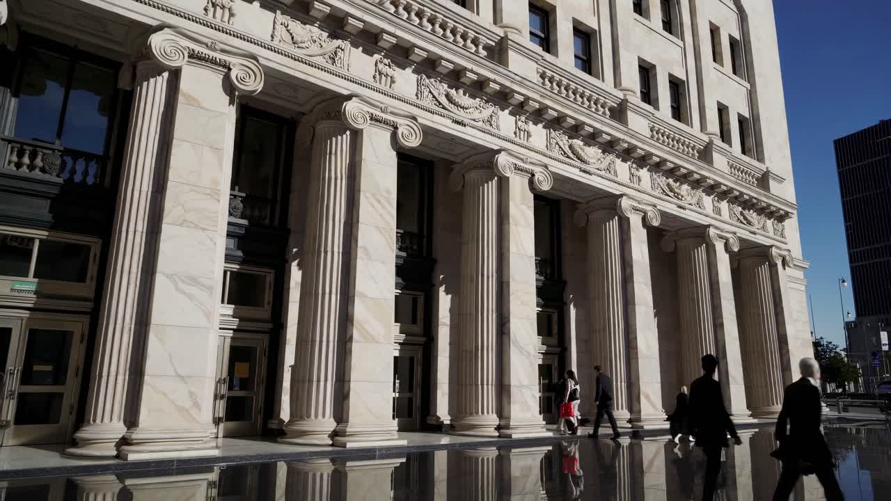 Low-angle video shot of a neoclassical building with grand columns and intricate carvings