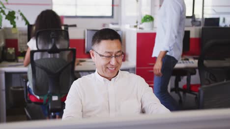 senior businessman talking on his smartphone and celebrating his success in office in slow motion