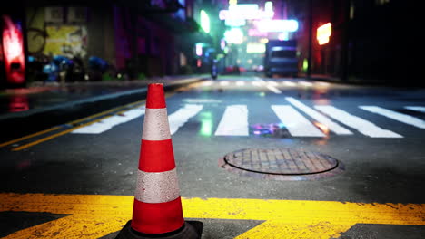 traffic cone on a wet street at night