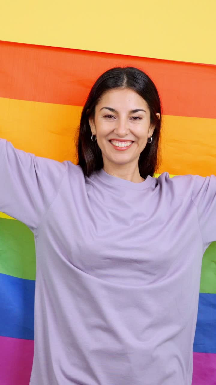 Happy woman celebrating with a rainbow pride flag