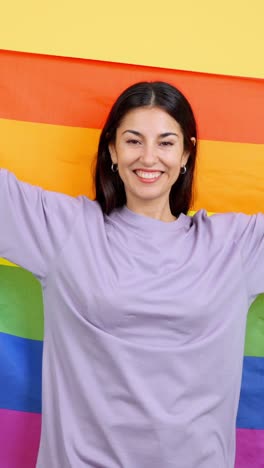 happy woman celebrating with a rainbow pride flag