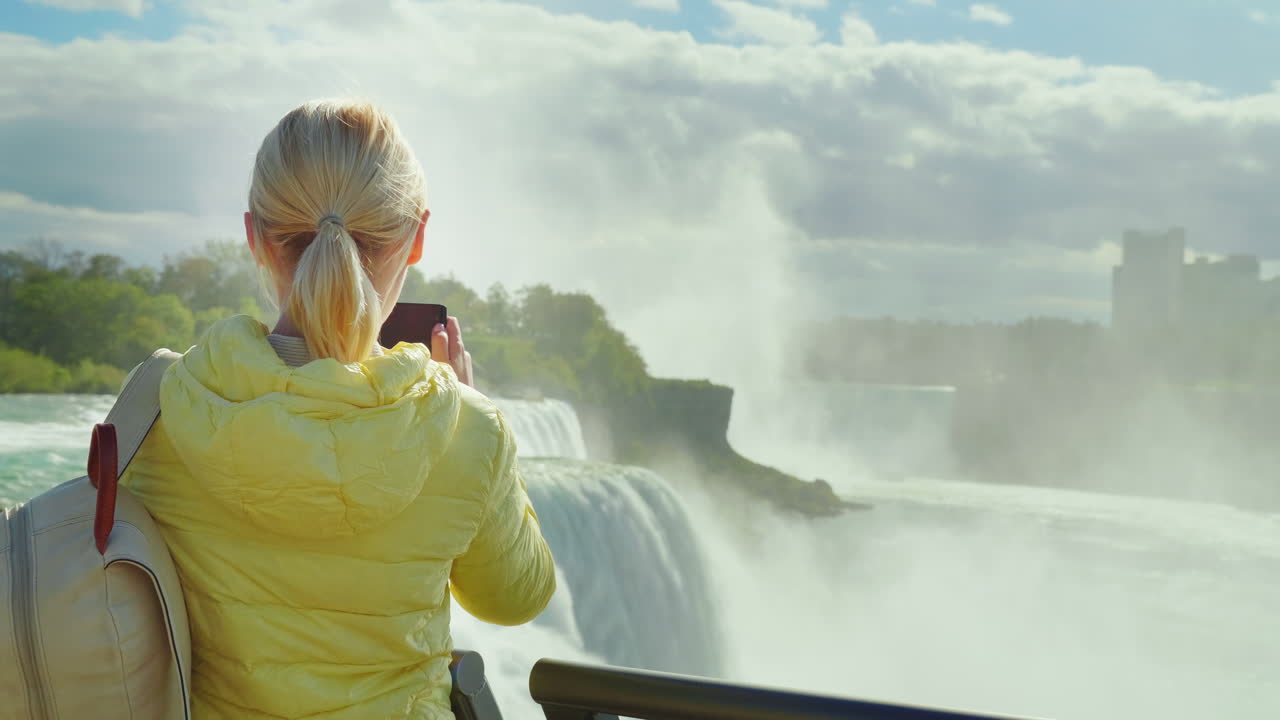 turista toma fotos de las cataratas del niágara