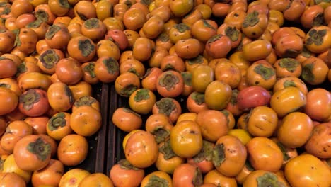 persimmons arranged at springvale market in melbourne