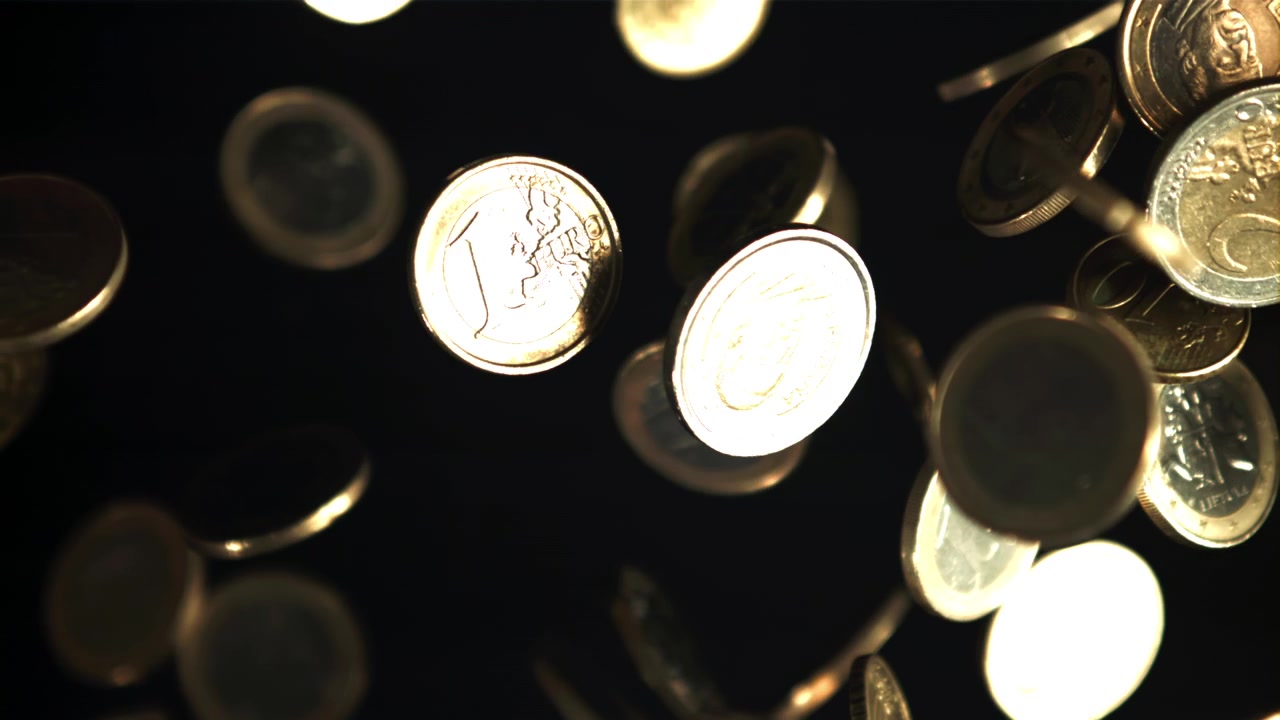 Golden Euro Coins Falling and Spinning in Slow Motion