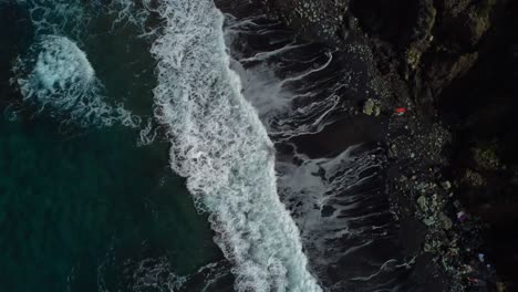 cinematic 4k aerial drone video of black beach and rolling waves - taken in benijo, tenerife