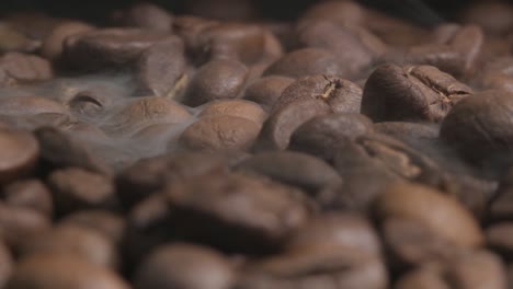 close up slow motion shot of smoke released during the roasting of organic coffee beans