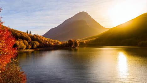 autumn landscape with lake and mountains at golden hour