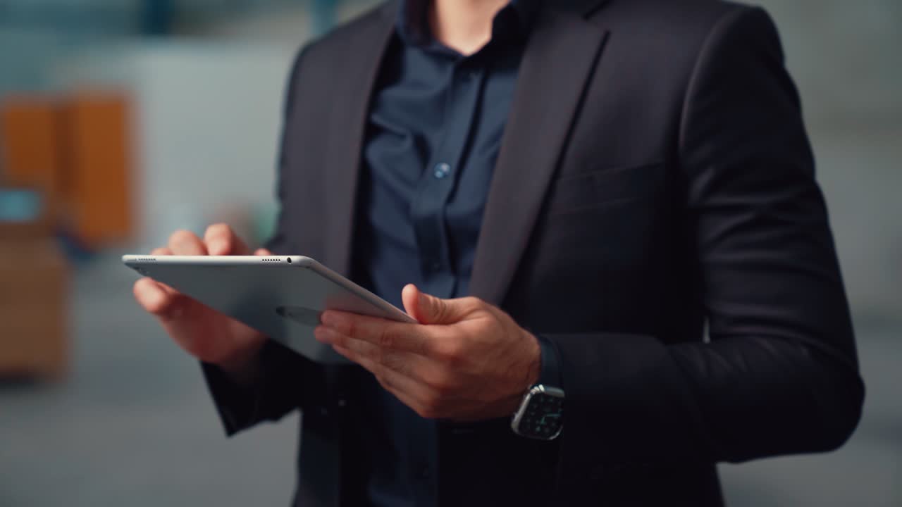 Factory manager using tablet computer in warehouse or factory