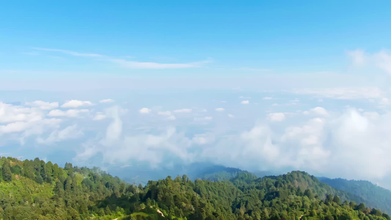 Aerial View of Mountains, Clouds, and Forest