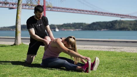 Young-couple-training-together-in-summer-park.