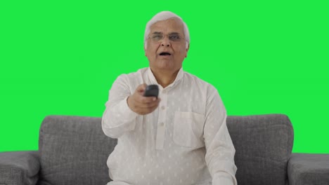 Sleepy-Indian-old-man-watching-TV-and-yawning-Green-screen