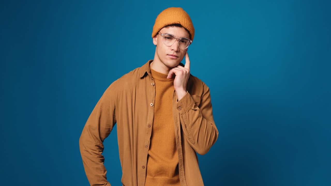 Portrait of a man with glasses and a beanie