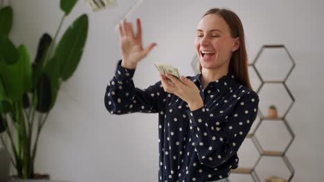 a crazy woman screams, scattering banknotes, a lot of dollars.