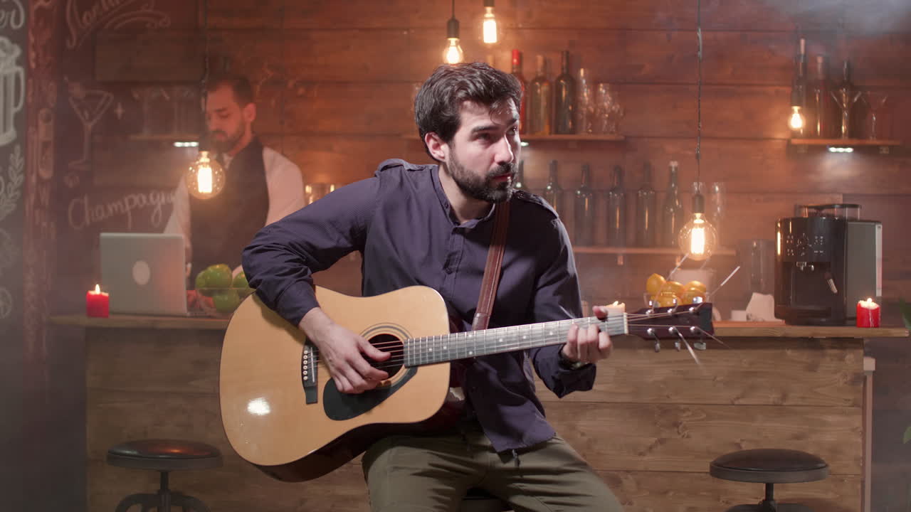 Man playing guitar in a bar