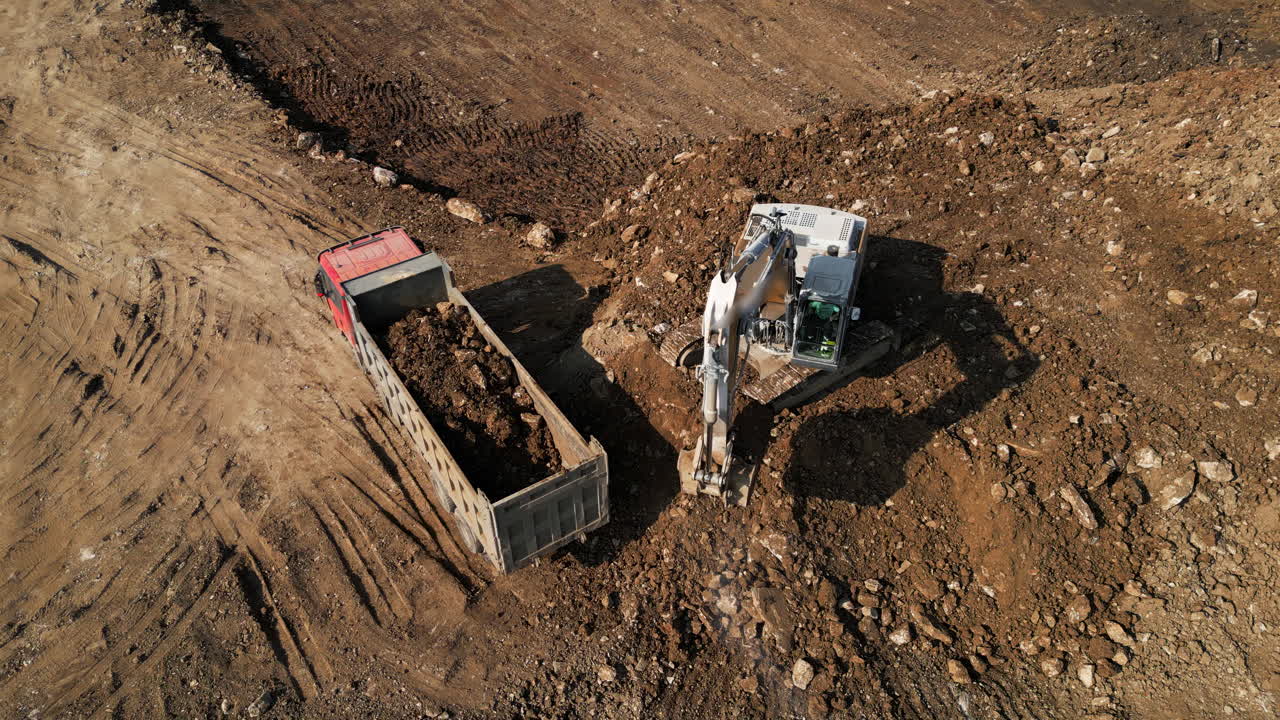 Excavator Loading Dump Truck at Construction Site