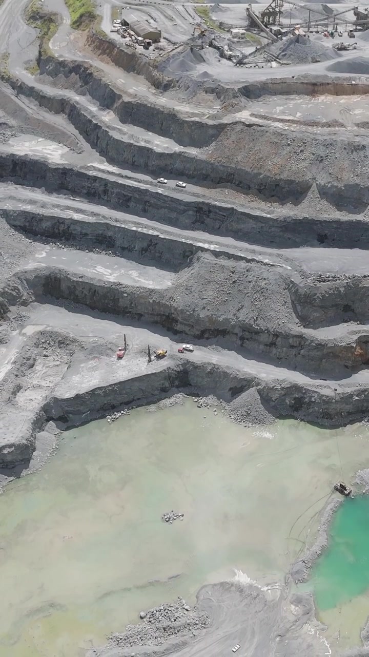 Drone captures layered quarry with water pools