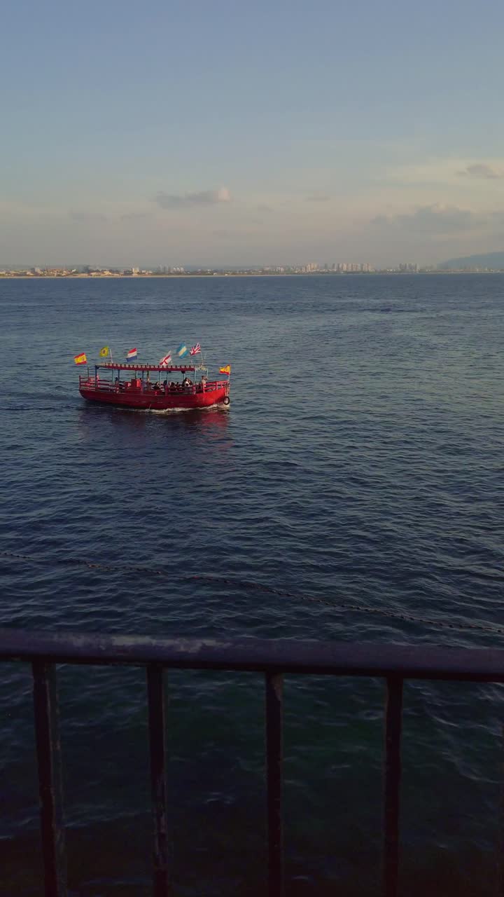 Red tourist boat sailing in the Mediterranean sea near Acre old city, Israel