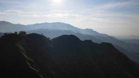 Aerial-drone-forward-moving-shot-over-Little-Adams-peak-in-Sri-Lanka-with-sun-rising-in-the-background