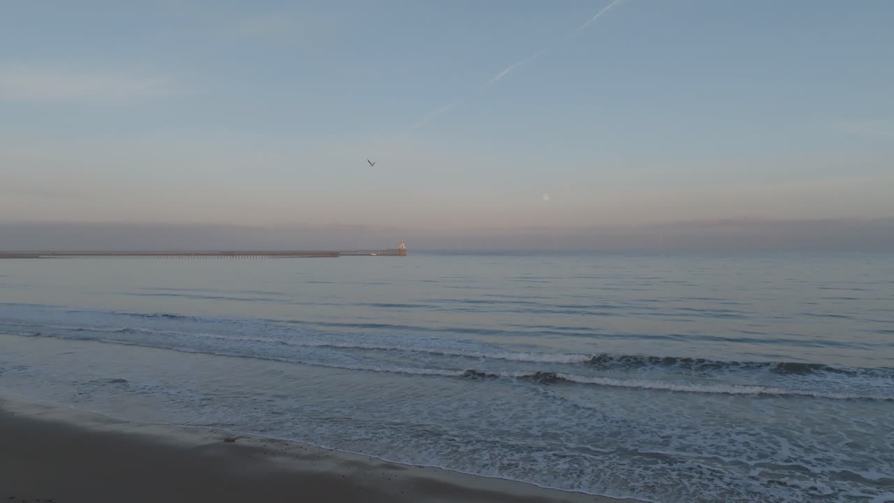 Blyth Lighthouse framed by the gentle hues of twilight and the brilliance of a full moon.
