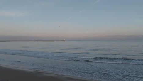 Blyth Lighthouse framed by the gentle hues of twilight and the brilliance of a full moon.