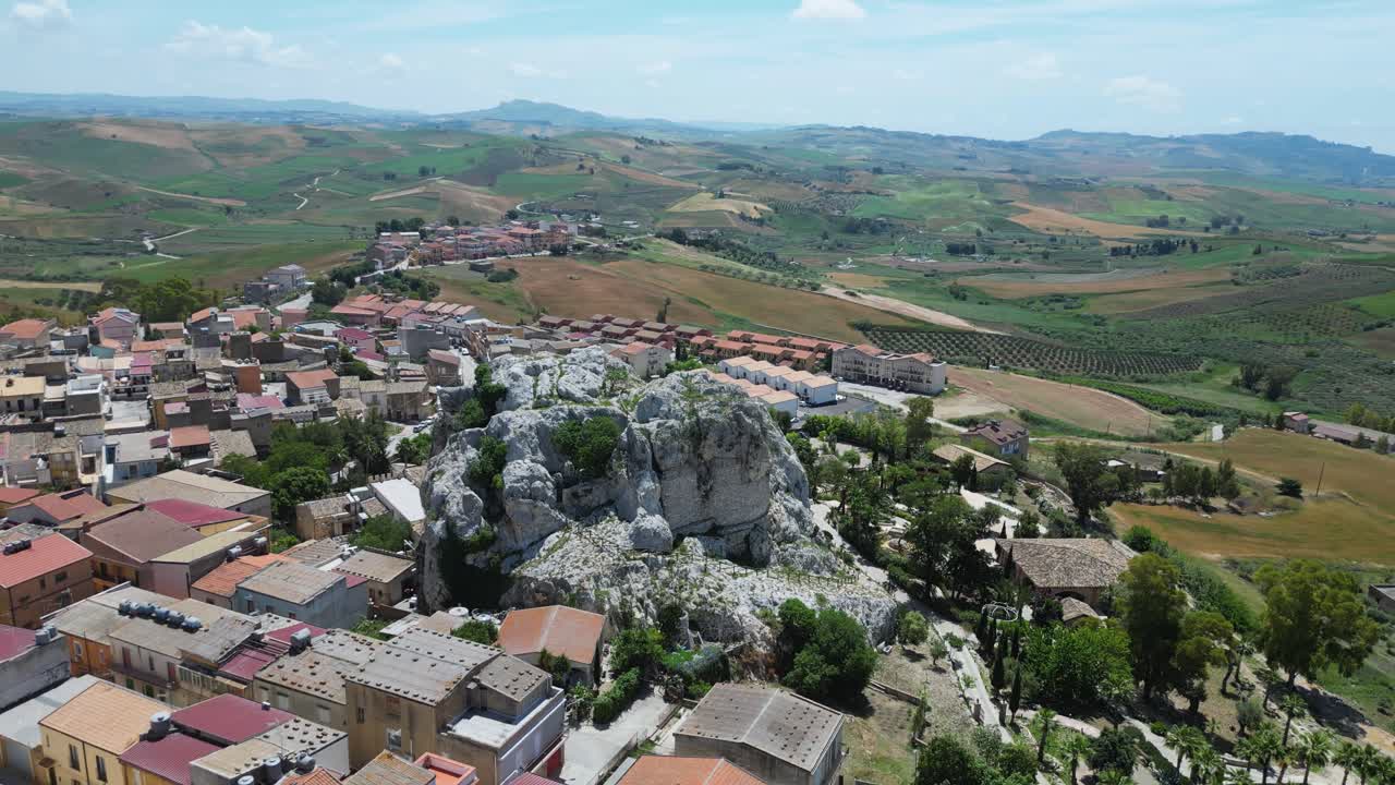 Aerial drone footage of Joppolo Giancaxio, Sicily: peaceful hilltop village surrounded by countryside, olive groves, and rolling hills. Perfect for travel, culture, and documentary projects