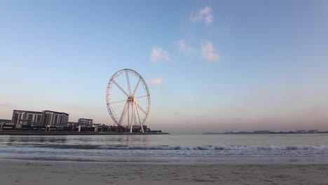 time-lapse big wheel in dubai marina, sunrise, wide angle, static shot