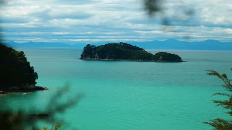 abel tasman allure: island peeking through lush trees