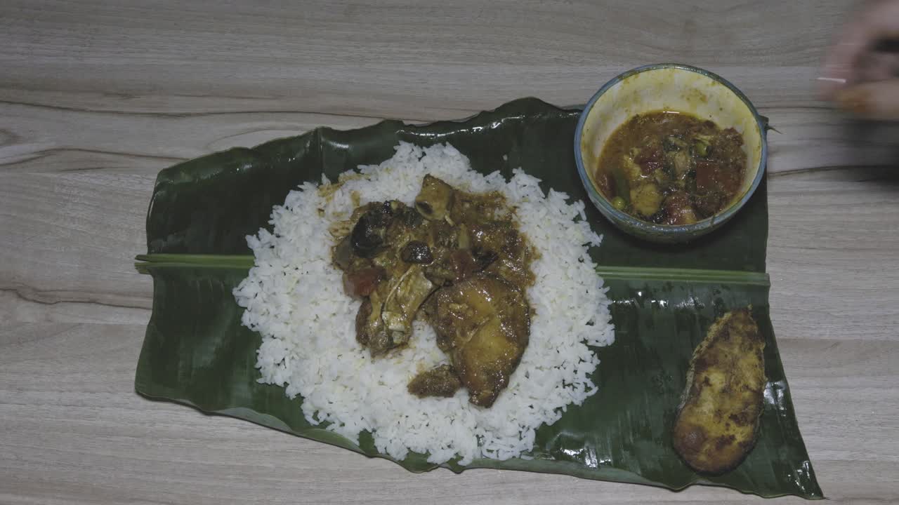 fresh and hot fish and rice cooked meal served at banana leaf for dinner