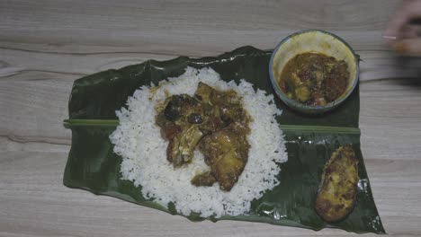 fresh and hot fish and rice cooked meal served at banana leaf for dinner