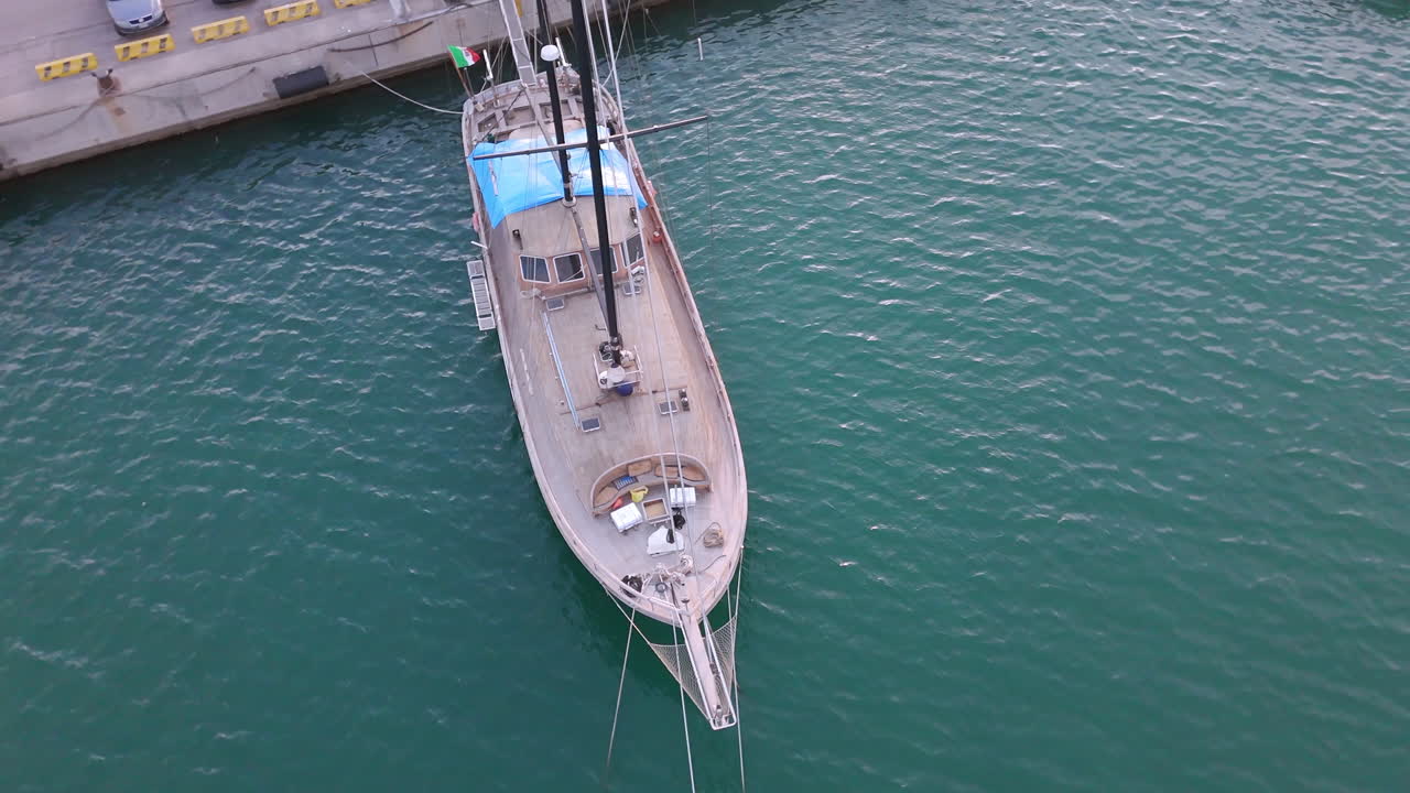 Aerial View of a Wooden Sailboat Moored at a Dock