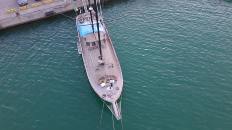 aerial view of a wooden sailboat moored at a dock