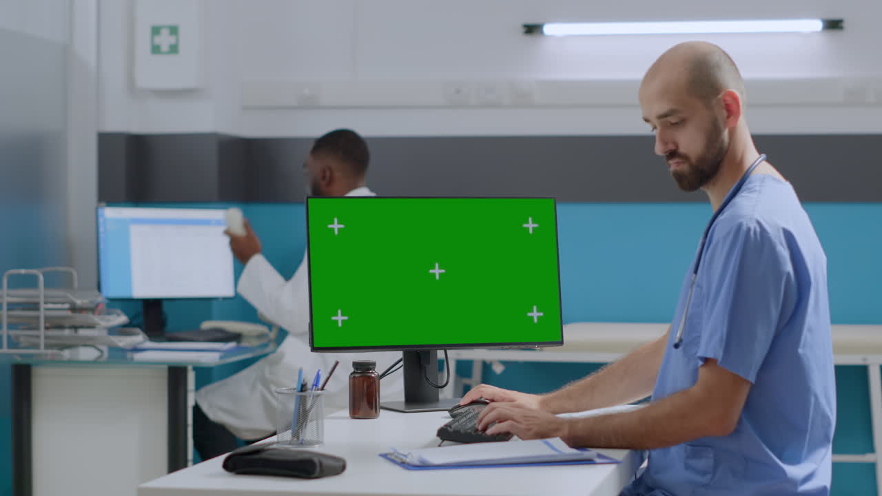 Doctors Working with Green Screen Computer in Hospital Office