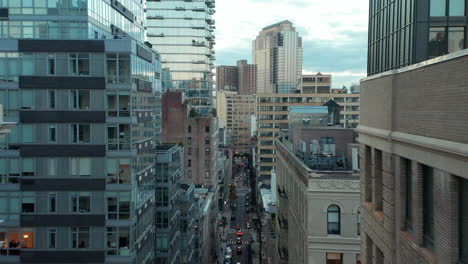 Forwards-fly-above-Civic-Centre-buildings-with-flags-on-rooftop.-Large-high-rise-buildings-in-city.-Manhattan,-New-York-City,-USA