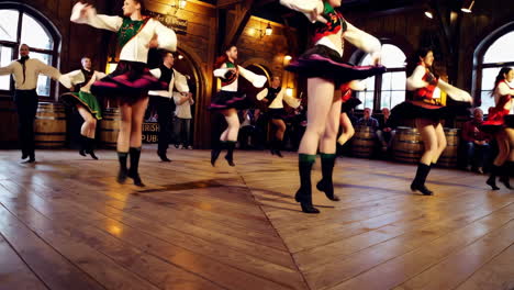 irish step dancers performing in a traditional pub setting
