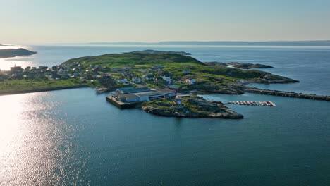 drone circling king crab production facilities in pykeija, sunny day in norway