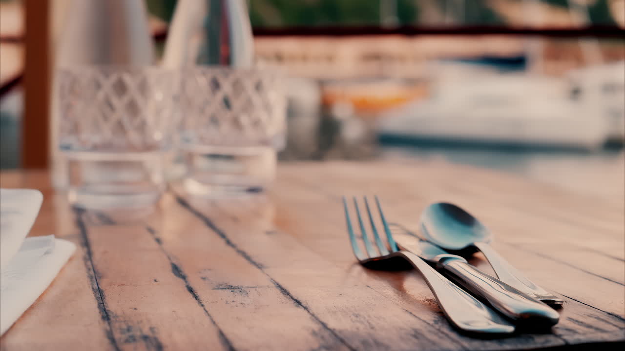 Close up view of a set table and the atmosphere at a restaurant near a port in the south of France