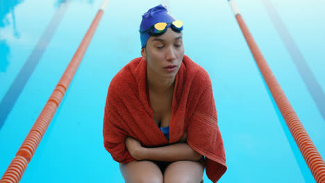 female swimmer sitting near swimming pool 4k