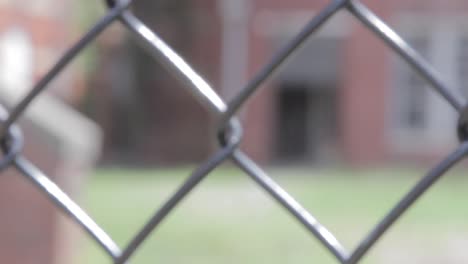 rack focus of fence and old building