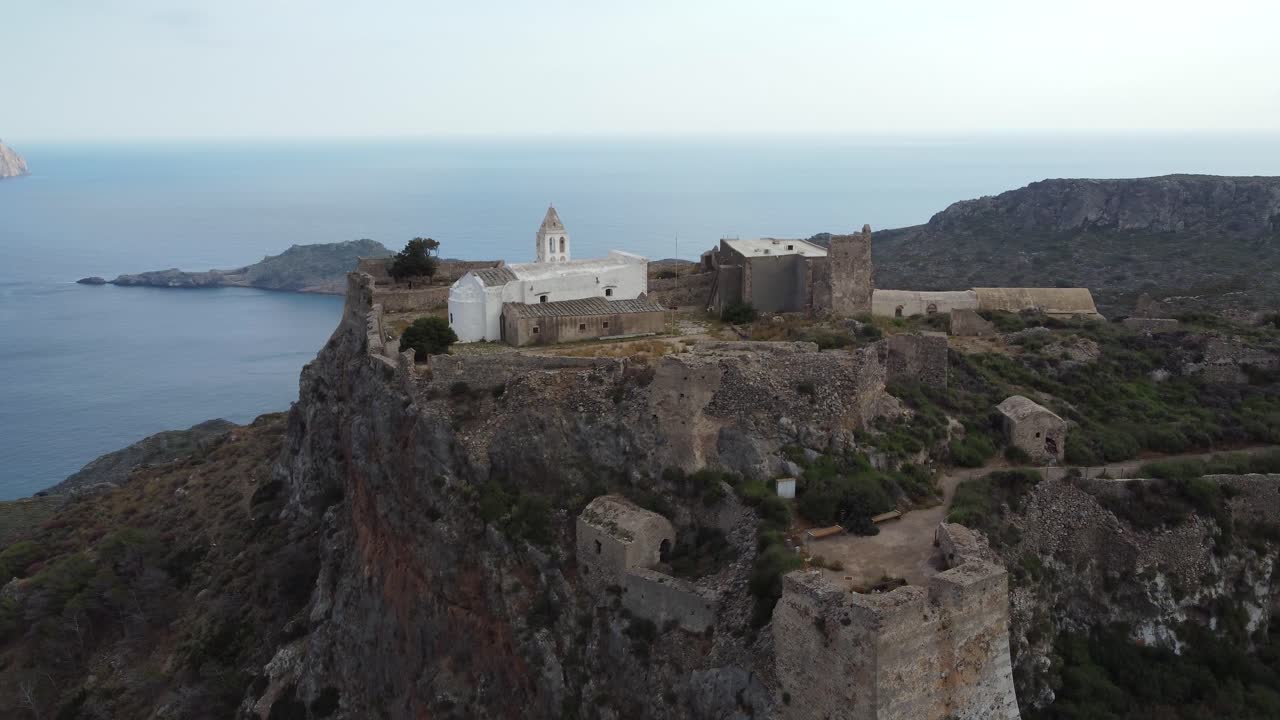 Aerial Orbital Cinematic View over Castle of Chora Kythira Revealing Kaps&aacute;li Bay, Greece