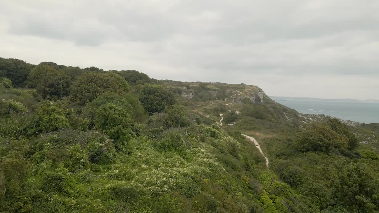 Drone flying low and close to the ground on the island of Portland, in Dorset UK, passing by the ruins of Rufus Castle.